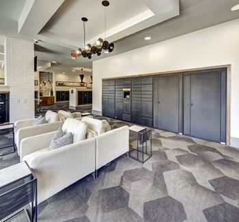 A modern living room with a white couch and a black and white rug at Arise Riverside Apartments, Austin, TX